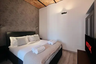 a bedroom with a bed with two towels on it at Circo Massimo Suite - In the heart of Testaccio in Rome