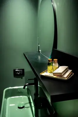 a bathroom with a counter with a mirror and a sink at Gracchi39 Apartment in Rome
