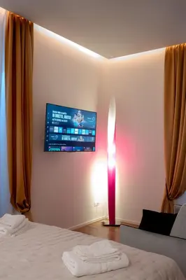 a bedroom with a bed and a tv on the wall at Gracchi39 Apartment in Rome