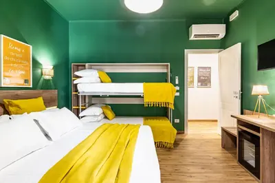 a bedroom with green walls and two bunk beds at Notte Ai Colli - Rooms & Kitchen in Rome
