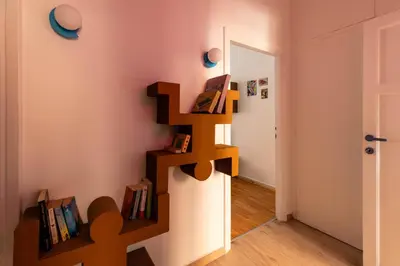 a room with a book shelf on the wall at Cappuccino Pop, Apartment Metro A in Rome