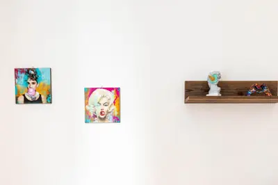 a group of four pictures on a wall at Cappuccino Pop, Apartment Metro A in Rome