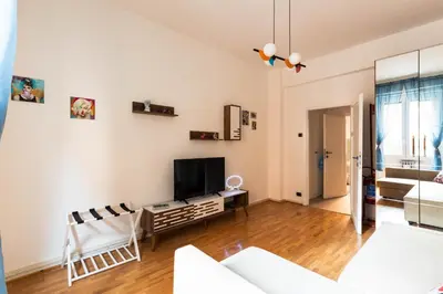 a living room with a couch and a tv at Cappuccino Pop, Apartment Metro A in Rome