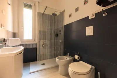 a bathroom with a white toilet and a sink at Cappuccino Pop, Apartment Metro A in Rome