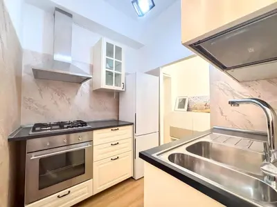 a kitchen with a stainless steel sink and a stove at Modern apartment with Private Balcony Near Colosseum in Rome