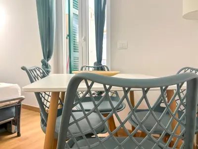 a table and chairs in a room with a table at Modern apartment with Private Balcony Near Colosseum in Rome