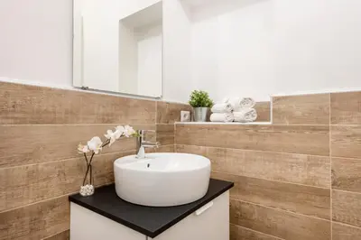 a bathroom with a sink and a mirror at Black Rooms Colosseo in Rome