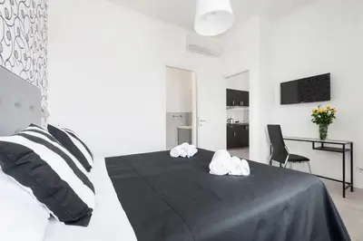 a bedroom with a bed with two towels on it at Black Rooms Colosseo in Rome