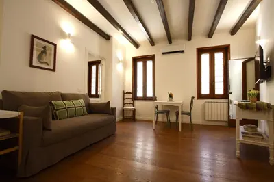 a living room with a couch and a table at Serpenti Holiday House in Rome
