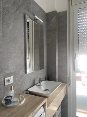 a bathroom with a sink and a mirror at Celestina Holiday Home Policlinico Gemelli in Rome