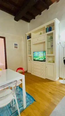 a living room with a white table and a tv at Anna Stellarum in Rome