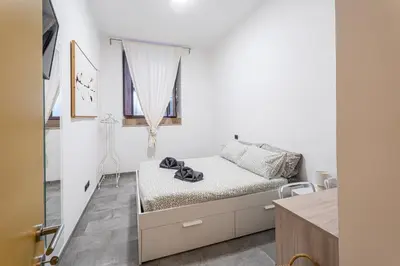 a small bedroom with a bed and a window at Sallustiano - Porta Pia - Rooms in Rome