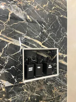 a marble wall with four lights on it at San Giovanni Suite Rome in Rome