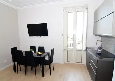 a dining room with a black table and black chairs at San Giovanni Suite Rome in Rome