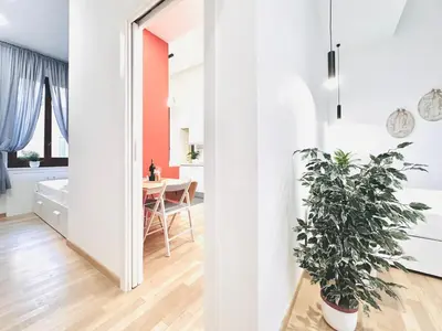 a kitchen and dining room with a potted plant at San Giovanni Lulus Home in Rome