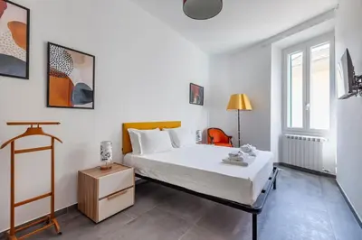 a white bedroom with a white bed and a window at Ponte Milvio 3 Bedroom Apartment in Rome