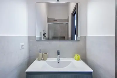 a bathroom with a sink and a mirror at Ponte Milvio 3 Bedroom Apartment in Rome