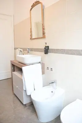 a bathroom with a sink and a toilet and a mirror at Tasso 39 in Rome