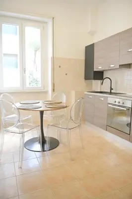 a kitchen with a table and chairs in a room at Tasso 39 in Rome