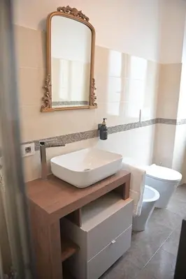 a bathroom with a sink and a mirror and a toilet at Tasso 39 in Rome
