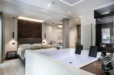 a large bathroom with a large tub in front of a bed at Junior Deluxe in Rome