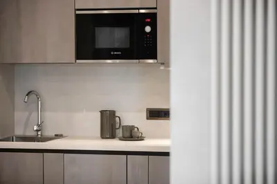 a kitchen with a sink and a microwave at Junior Deluxe in Rome