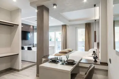 a living room with a dining table and a kitchen at Junior Deluxe in Rome