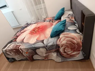 a bed with flowers on it in a room at Ponte Milvio-Olympic Stadium Modern Apartment in Rome