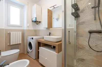 a bathroom with a sink and a washing machine at Ponte Milvio-Olympic Stadium Modern Apartment in Rome