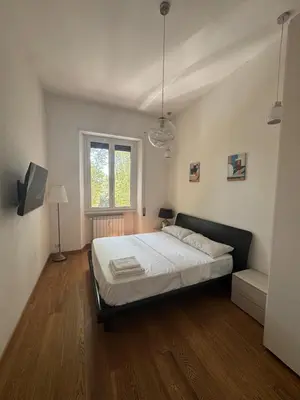 a bedroom with a bed and a window at Victoira's appartament in Roma in Rome