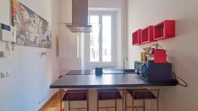 a kitchen with a black counter top in a room at Victoira's appartament in Roma in Rome