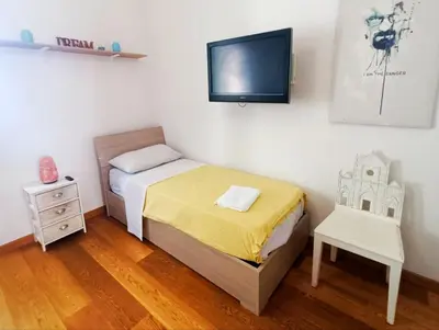 a small bedroom with a bed and a chair at Victoira's appartament in Roma in Rome