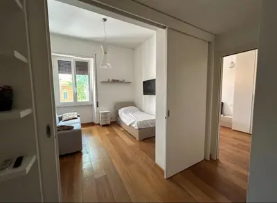 a bedroom with a bed and a living room at Victoira's appartament in Roma in Rome