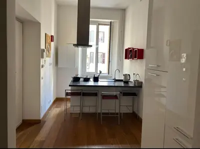 a kitchen with a black counter top in a room at Victoira's appartament in Roma in Rome