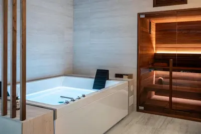 a bath tub in a bathroom with a shower at Pool & Spa Deluxe in Rome