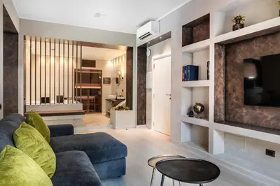 a living room with a couch and a tv at Pool & Spa Deluxe in Rome