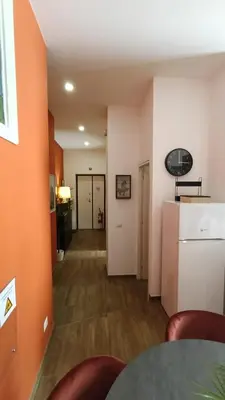 an empty room with a hallway with a refrigerator at Laterano 190 apt at Colosseo in Rome