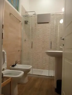 a bathroom with a sink and a toilet and a shower at Laterano 190 apt at Colosseo in Rome