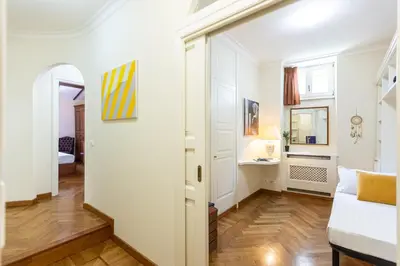 a living room with white walls and a white couch at Monti Atmosphere Apartment by Rental in Rome in Rome