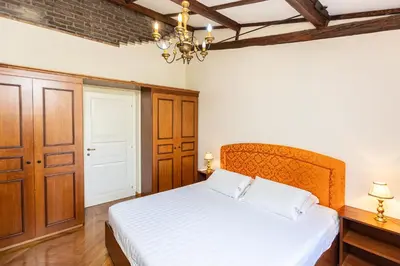 a bedroom with a bed and a chandelier at Monti Atmosphere Apartment by Rental in Rome in Rome