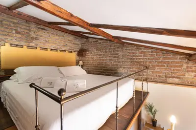 a bed in a room with a brick wall at Monti Atmosphere Apartment by Rental in Rome in Rome