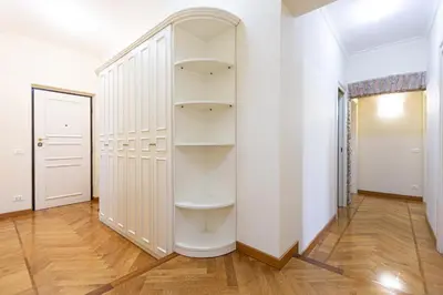 a walk in closet with white shelves at Monti Atmosphere Apartment by Rental in Rome in Rome