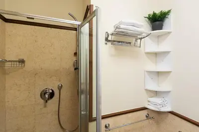a shower with a glass door in a bathroom at Monti Atmosphere Apartment by Rental in Rome in Rome