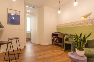 a living room with a couch and a table at Eufonia Vatican Golden Suites in Rome
