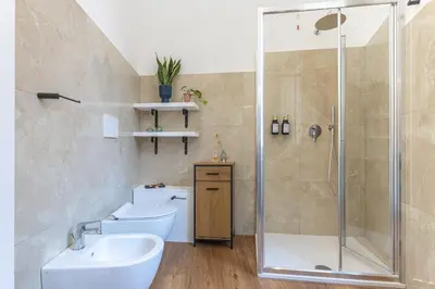 a bathroom with two sinks and a shower at Eufonia Vatican Golden Suites in Rome