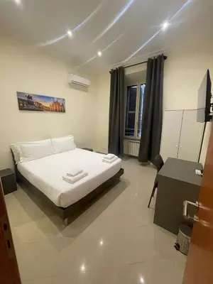 a bedroom with a bed and a desk in it at Rome jubilee stays 2 in Rome