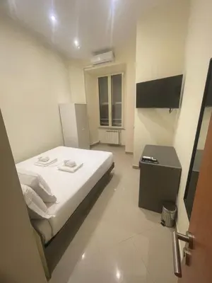 a bedroom with a bed and a television in it at Rome jubilee stays 2 in Rome