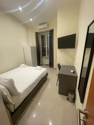 a small bedroom with a bed and a desk at Rome jubilee stays 2 in Rome