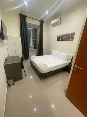 a bedroom with a bed and a desk and a door at Rome jubilee stays 2 in Rome