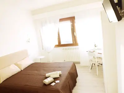 a bedroom with a bed with two candles on it at B&B More Than Rome in Rome